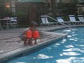 Ben pretending to be a frog while he jumps into the pool.
