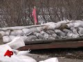 National Guard crews are trying to hold back the bloated Red River near Fargo by dropping huge sandbags. Residents meanwhile are just trying to get through it. (March 20)