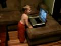 Peter dancing to Tigger song and scrolling through music on Computer