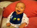 Little Nolan laughing at his parents