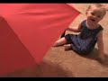 Baby laughs at umbrella Baby laughs at umbrella