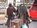 a robot, streetmusician