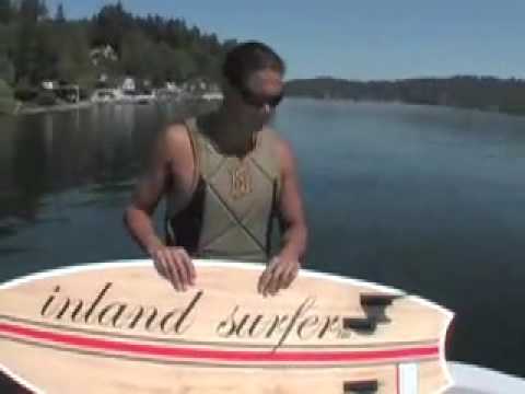 Lance riding behind a Centurion on Inland Surfer Swallow board