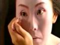 Maiko or geisha putting on face make-up in Kyoto