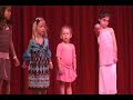 Pie watches as other kids on stage do the Hokey Pokey, then has the spirit hit her right at the end.