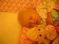 Stella sleeping with a doll baby