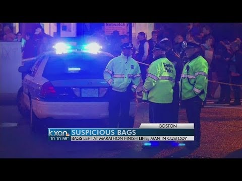 boston - Police have blown up two unattended backpacks found near the Boston Marathon's finish line. They say they've taken a man into custody in connection with them.