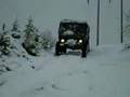 Unimog descending a steep hill in the snow