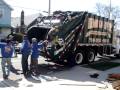 Dimola Bros team loading a rubbish removal truck.