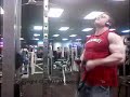 Huge muscle bodybuilder pumping arms and biceps