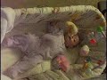 Vicky playing in bassinet