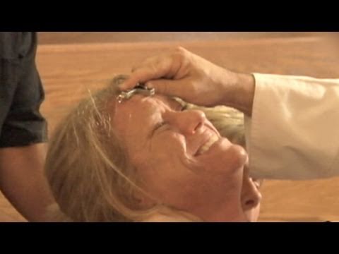 exorcism - Behind the scenes as priest casts demons out of possessed woman.