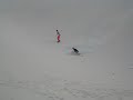 Sandboarding down a dune in Huacachina Peru