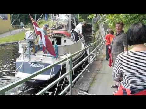 Dalsland - A sailing boat passing the locks and the aqueduct in Håverud Sweden.