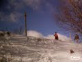 Snowboarder goes down hill then does 180