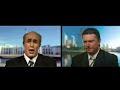 ben price as john howard in a mock satellite interview, interviewed by james o'neil