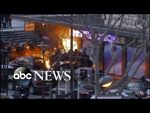 Paris - French authorities storm the market where a terror suspect was holding hostages.