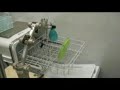 Robot unloads items from a dishwasher.
