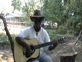 environment man sings and plays kum ba ya in the garden of nede.