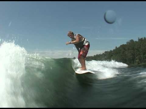 Jeff riding behind a Centurion on Inland Surfer Red Woody board