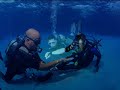 underwater warriors is a foundation, which provides a powerful alternative of rehabilitation to our wounded soldiers through scuba. this video takes place off the coast of the serene tropical island of cayman brac. you will see the beauty and continued courage of our wounded heroes as they move forward with confidence and wonder in the freedom they find beneath the sea. you will also see a sculpture of the mythical world of the sunken city of atlantis as envisioned by local cayman brac artist, 