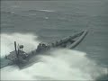 A Navy rib in rough conditions filmed from helicopter