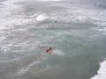Lifeguard leaps of HB pier to save 3 girls at once.