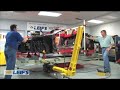 watched by students from springdale jcc, leif and john from car bench start to pull the ferrari into shape.