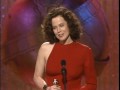 Phil Collins and Shelly Long present the Best Supporting Actress in a Motion Picture Award. Phil jokingly tells Shelly Long to put her heels on referring to the fact that she is taller him. Shelly Long then compliments him by saying that he is a great presenter. Sigourney Weaver wins the award for Supporting Actress in a Motion Picture for the Working Girl. She says that her award is for the bad girls and says that the picture has a wonderful cast, script, and amazing director, and thanks the Hollywood Foreign Press Association.