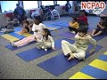 Photo of children with disabilities in a yoga class practicing eye exercises.
