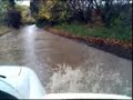 Driving up flooded road