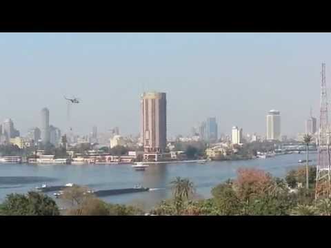 nostrovius - Army helicopters lowering water buckets into the Nile, south of Zamalek island, to help put out fires set by protesters at the Egyptian Football Federation h...