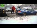 A Subaru WRX STi pulls a semi stuck in the snow
