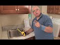 http://www.askthebuilder.com host tim carter demonstrates why the size of your overmount stainless steel sink determines whether you should install your sink before or after the countertop is in place.