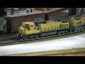 Custom Kato x-CNW C44-9W UP 9771 and Kato C44-9W UP9581 handle a stack train.