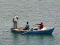 In the autumn of 2004 and again in the spring of 2008 I was able to join two cruises which included Suez Canal transits.  In November 2004 I sailed south from Alexandria to Mombasa, Kenya on the 10,000-ton, 208-passenger Seabourn Spirit; and in May 2008 I sailed north during an Africa circumnavigation cruise on Holland America Line's 38,000-ton, 793-passenger Prinsendam. The Suez Canal was constructed by forced labor at a cost of USD 100 million over a 10 1/2-year period by Ferdinand de Lesseps' Universal Company for the Suez Maritime Canal, which was formed in 1858.  The canal was opened on November 17, 1869 by the French Empress Eugenie.  163 km (101 miles) long and 600 meters (1,968 feet) wide in its narrowest stretch, the canal links the Mediterranean at Port Said to the Red Sea at Suez.  With an average transit time of 15 hours, the canal saves ships 11,829 km (7,350 miles) compared to the circumnavigation of Africa.The Suez Canal, which has no locks, accommodates about 50 ships daily and is capable of handling up to 80 ships in a single day.  The current maximum draft allowed is 16 meters (53 feet), and modifications now underway should increase this to 22 meters (72 feet).  While ships which displace up to 150,000 tons can now transit the canal, after 2010 fully-laden supertankers will also be able to pass.  At present supertankers have the option of transferring a portion of their cargo onto an Egyptian boat and then reloading after their canal transit.  Incredibly, the average toll is USD 205,000.  So it is difficult to imagine what the cost must be to operate a supertanker all the way around the Cape of Good Hope.  No wonder supertankers would bother to offload and reload cargo in order to transit the canal!  In 2005 some 18,193 vessels, or about 7.5% of worldwide shipping, crossed through the Suez Canal.  Transit fees routinely total well over USD 3 billion.While only a single shipping lane exists in the canal, there are two major turnouts for passing.  Typically three convoys transit the canal daily.  The initial southbound convoy departs Port Said and proceeds as far as the Great Bitter Lake south of Ismailia.  There the convoy awaits the northbound convoy before continuing south to Suez.  The second southbound convoy is passed by the northbound convoy in the bypass at El Ballah between Ismailia and El Qantara.  In order to reduce erosion, transit speeds are held to about 8 knots or some 15 km (9 miles) per hour.  Both of my Suez Canal transits were a little unusual.  The journey begins very early in the morning no matter which direction one's ship is traveling.  In 2004 Seabourn Spirit got the usual pre-dawn start from Port Said.  But our southbound transit time was greatly increased due to a reported minor ship collision in the northbound convoy.  The ensuing delay caused us to be sidelined in the Great Bitter Lake for a number of extra hours, and we only exited the canal at Suez very late that night.  On the other hand, in 2008 the captain of the Prinsendam was contacted by Suez Canal Authority officials a couple of hours early, at about 4 AM, and told to proceed as the lead ship in that day's northbound convoy.  As the captain thought it best to avoid making a public announcement on board at that early hour, by the time most passengers awoke, expecting to see Suez from their balconies, our ship was already sailing in the Little Bitter Lake.Passengers who transit the Suez Canal will glimpse many interesting vignettes of local life such as these fishermen.  The bad news is that, while lying at anchor, the local flies are nothing short of murderous!
