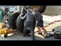how to change a main tire on an airbus: wait for the ramp temperature to be in the high 90's (37c)and have a load of impatient passengers. then find 3 or 4 of your best friends, an 85 ton jack and a 10 foot long 