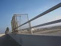 Biking on the Santa Ana River Channel Bridge with a Paramotor over head. Biking on the Santa Ana River Channel Bridge with a Paramotor over head.