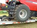loading a case ih 8010 onto a trailer for transport. this was early in the morning and there was still a little dew on the trailer, making it a bit slick.