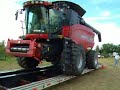 loading a case ih 8010 onto a trailer for transport. this was early in the morning and there was still a little dew on the trailer, making it a bit slick.