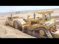Pair of D10N's push loading 660B scrapers