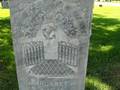 gravestone with book, & a drape with tassels
