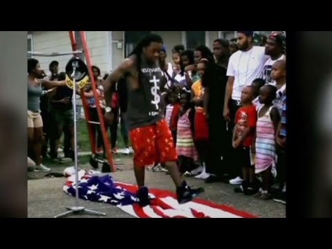 LIL - Rapper Lil' Wayne was filmed stepping on an American flag while shooting a video for his song