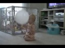 Ella playing with her first balloon
