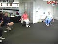 Image of  Parkinson's fitness class participants do exercises to warm up the shoulders and stretch the chest.