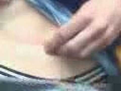 boy playing with his outie belly button