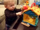 Tenan playing with his birdhouse