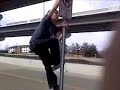 dylan climbs a sign