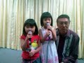 2 kids sing together with their grandfather during a dinner celebration on 19th july 2008.