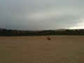 Throwing sand at Pismo Beach